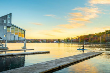 Sunrise over lake Banook with paddler